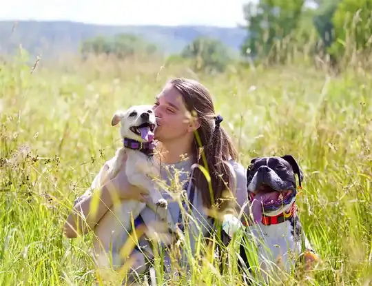 Jess Gorham with two of her dogs in a Vermont field