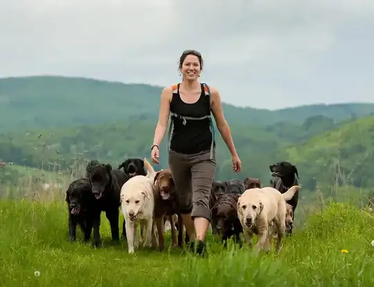 Rhonda Bilodeau leading her pack of dogs through Vermont hills